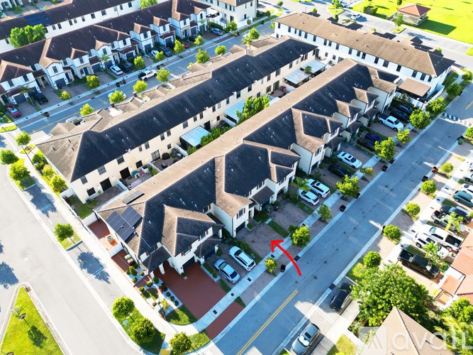 A red arrow points to a car in a parking lot.