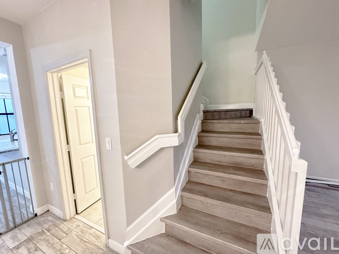 A staircase with a white railing and wooden steps.