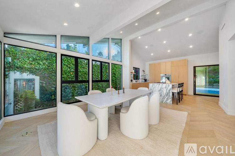 A modern dining room with a large table and chairs.
