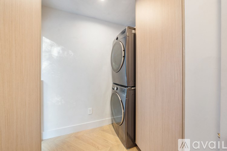 A modern kitchen with a wooden cabinet and a built-in dishwasher.