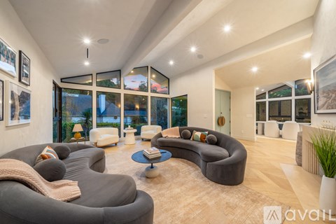 A modern living room with a grey sofa and a coffee table.