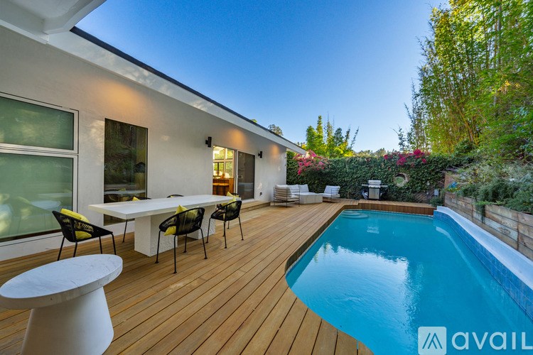 A modern house with a pool in the backyard.