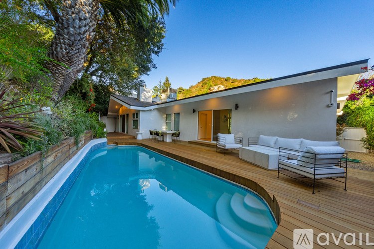 A modern house with a pool in the backyard.