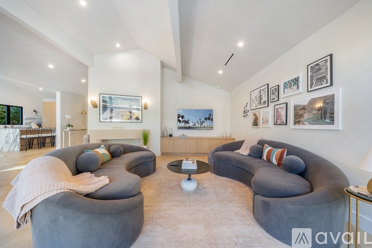 A living room with grey couches and a coffee table.