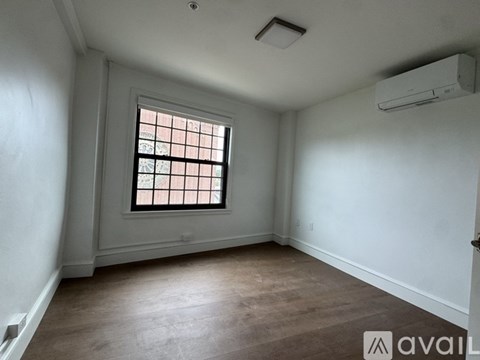 A room with a window and a ceiling fan.