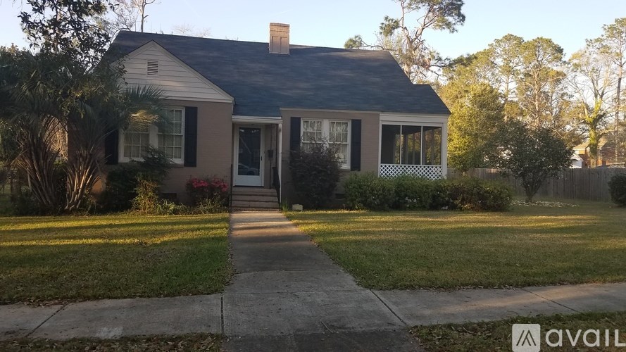A house with a front yard and a walkway leading to the front door.