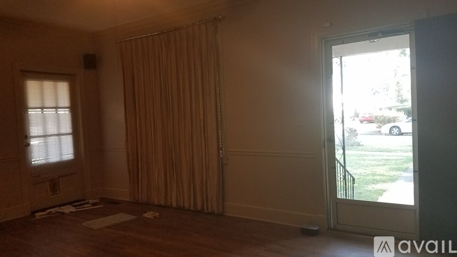 A room with a window and a door leading outside.