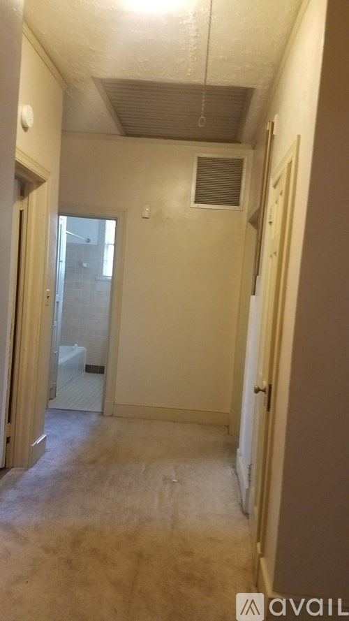 A long hallway with a door on the right.