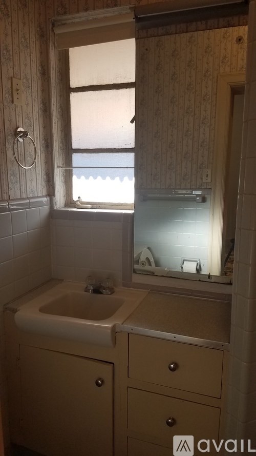 A bathroom with a sink and a window.