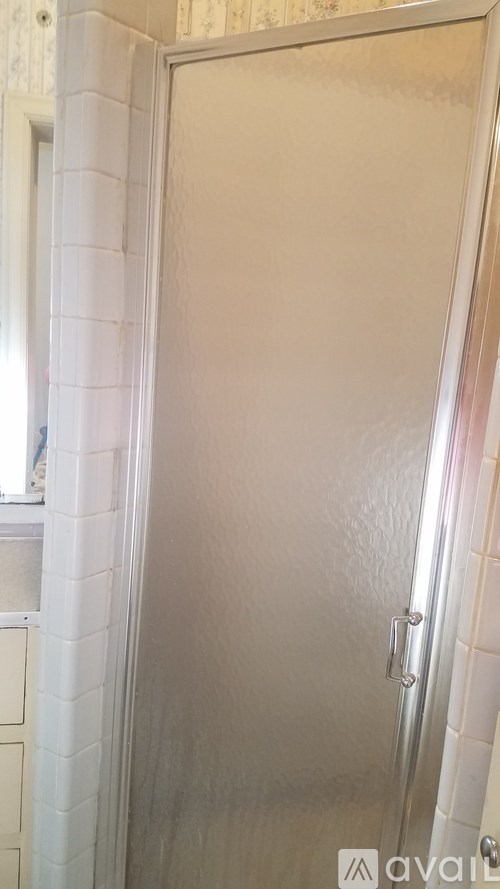 A white door with a silver handle is closed.