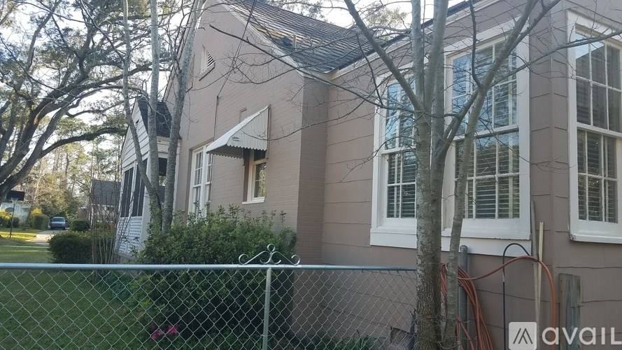 A house with a fence in front of it.