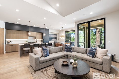 A modern living room with a grey sofa and a round coffee table.