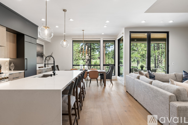 A modern kitchen with a dining table and chairs is available for rent.
