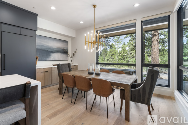 A modern dining room with a wooden table and chairs.