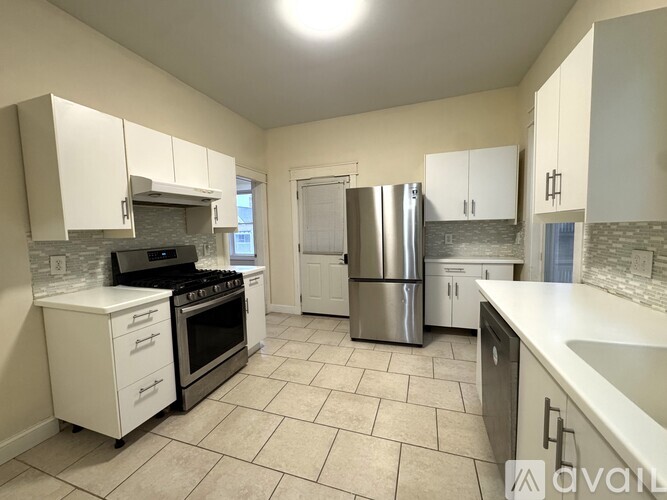 A kitchen with a refrigerator, cabinets, and a dishwasher.