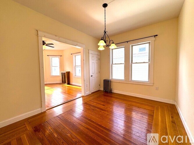 A dining room with a wooden table and chairs.