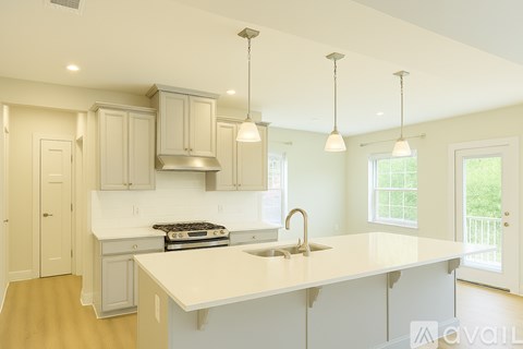 A kitchen with a white countertop and a stove top oven.