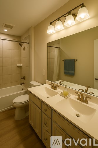 A bathroom with a toilet, sink, and mirror.