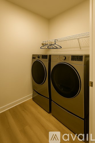 Two front loading washing machines in a laundry room.