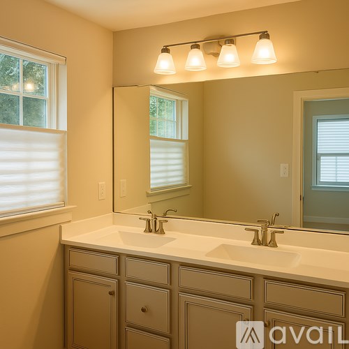A bathroom with two sinks and a large mirror.