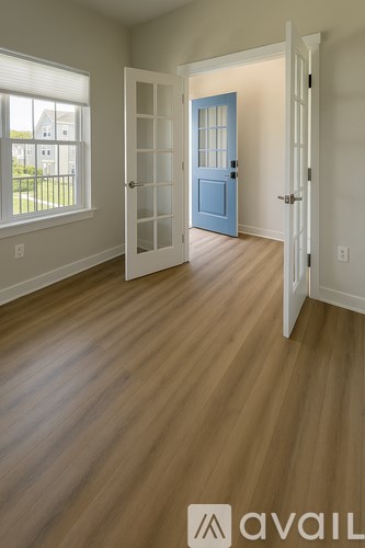 A room with a blue door and white walls.
