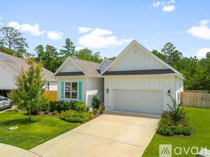 A house with a white garage door and a brown roof.