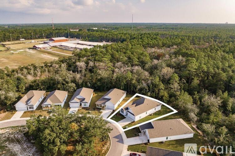 A bird's eye view of a residential area with houses and trees.