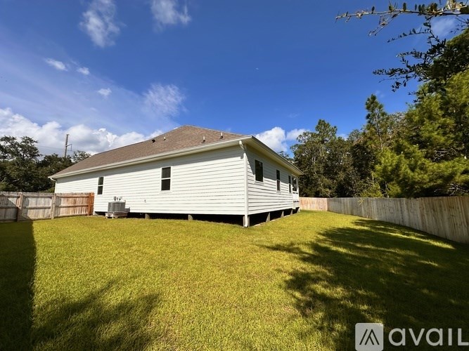 A house with a fence and a yard is for sale.