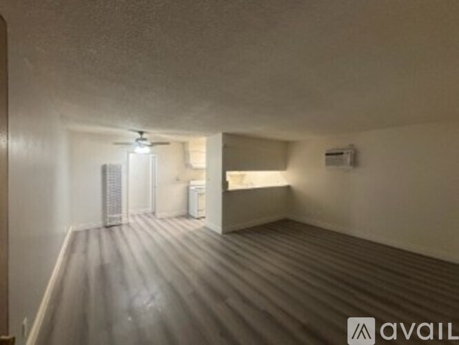 A room with a ceiling fan and a light fixture.