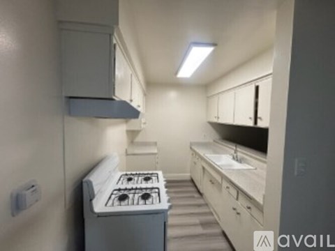 A small kitchen with a stove and a sink.
