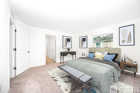 A bedroom with a bed, nightstand, and a bench.