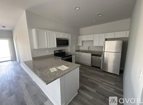 A kitchen with granite countertops and stainless steel appliances.