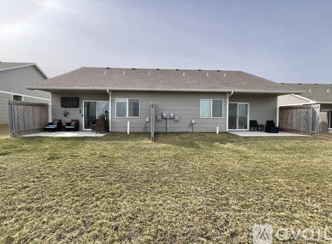 A house with a grey roof and a brown garage door.