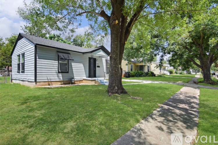 A small house with a tree in front of it.