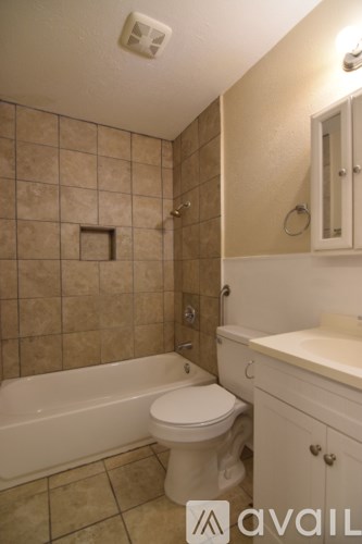 A room with wooden floors and a ceiling fan.