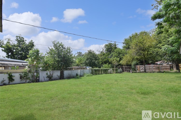 A bathroom with a toilet, sink, and tiled walls.