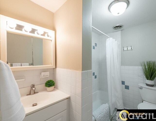 A white towel hangs on a bathroom sink.