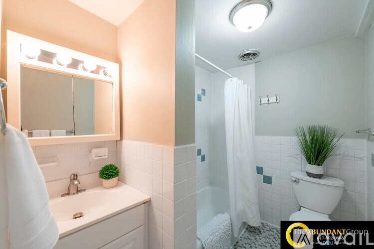 A bathroom with a white toilet and a white sink.