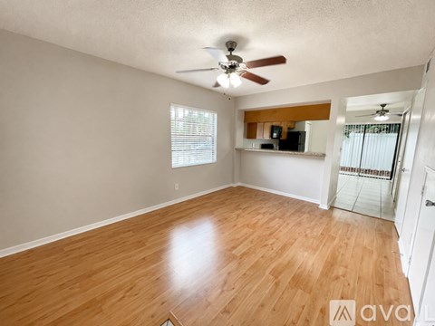 A kitchen with wooden cabinets and a stainless steel refrigerator.