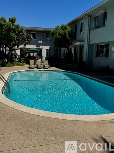 A swimming pool in front of a building with the logo "avail" on the bottom right.