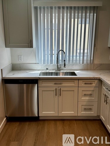 A kitchen with a sink and a dishwasher.