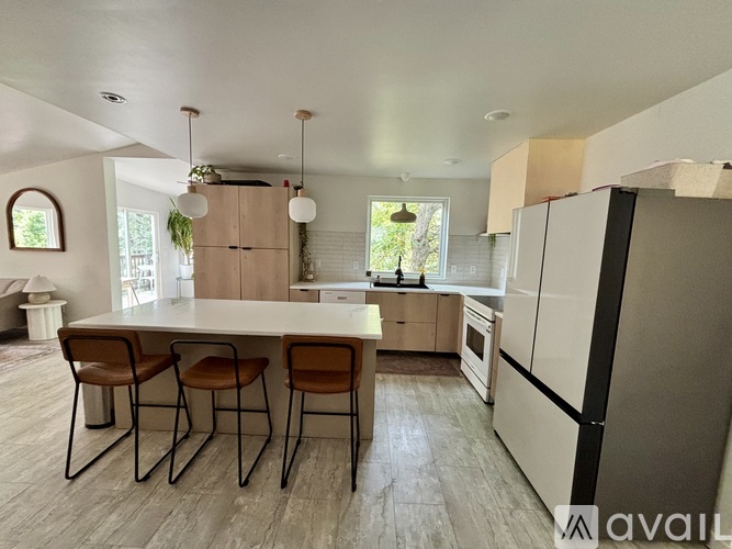 A kitchen with a table and chairs in the middle of the room.