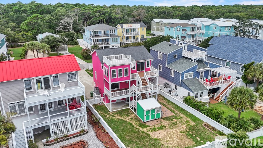 A bird's eye view of a row of houses with a red roof.