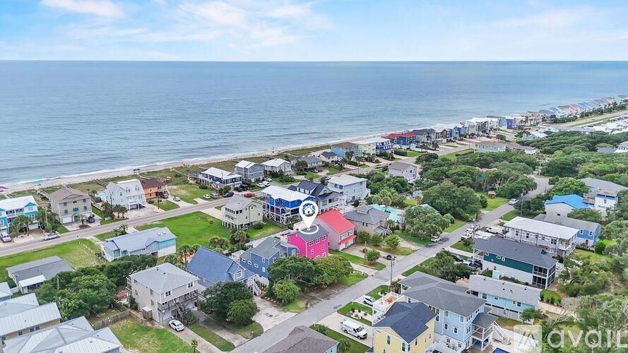 A bird's eye view of a coastal town with buildings in various colors.