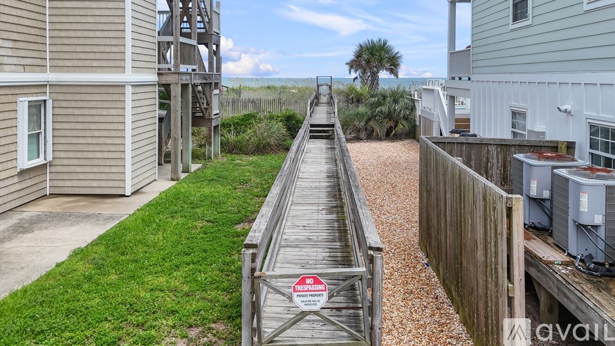 A wooden walkway with a red and white sign on it.