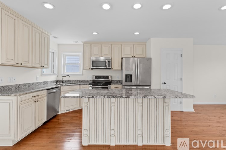 A kitchen with granite countertops and stainless steel appliances.