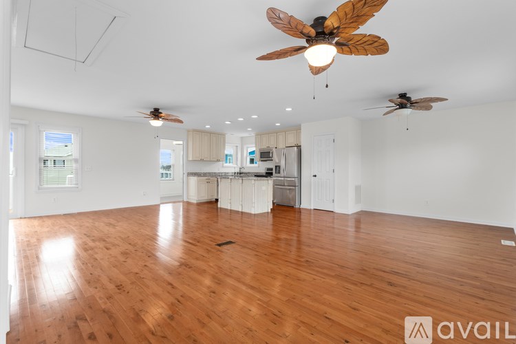 A room with wooden floors and a ceiling fan.