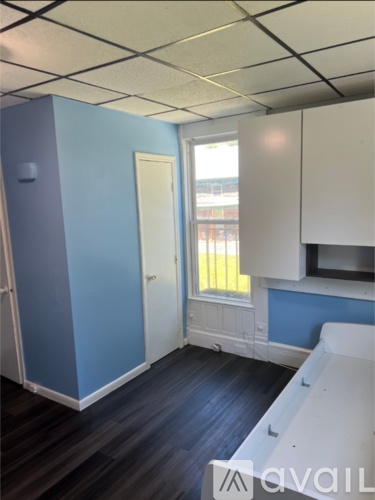 A room with blue walls and a window.