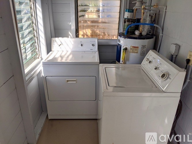 A white washing machine and dryer in a small room.