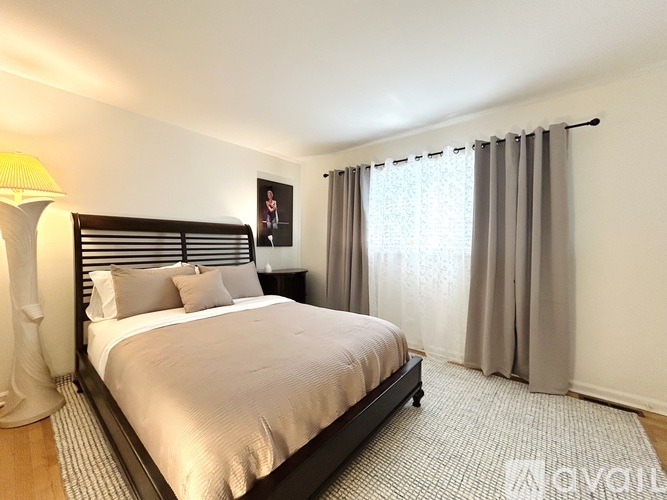 A bedroom with a large bed and a blue carpet.